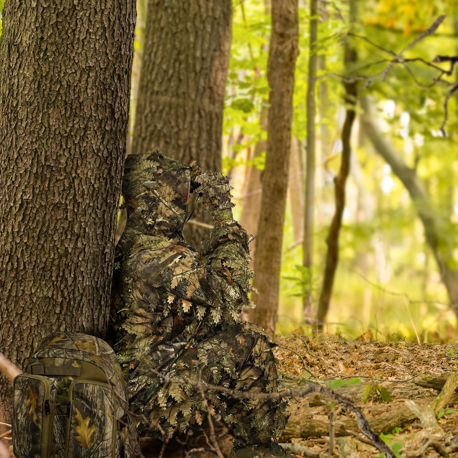 Hunter observing woodland from natural cover